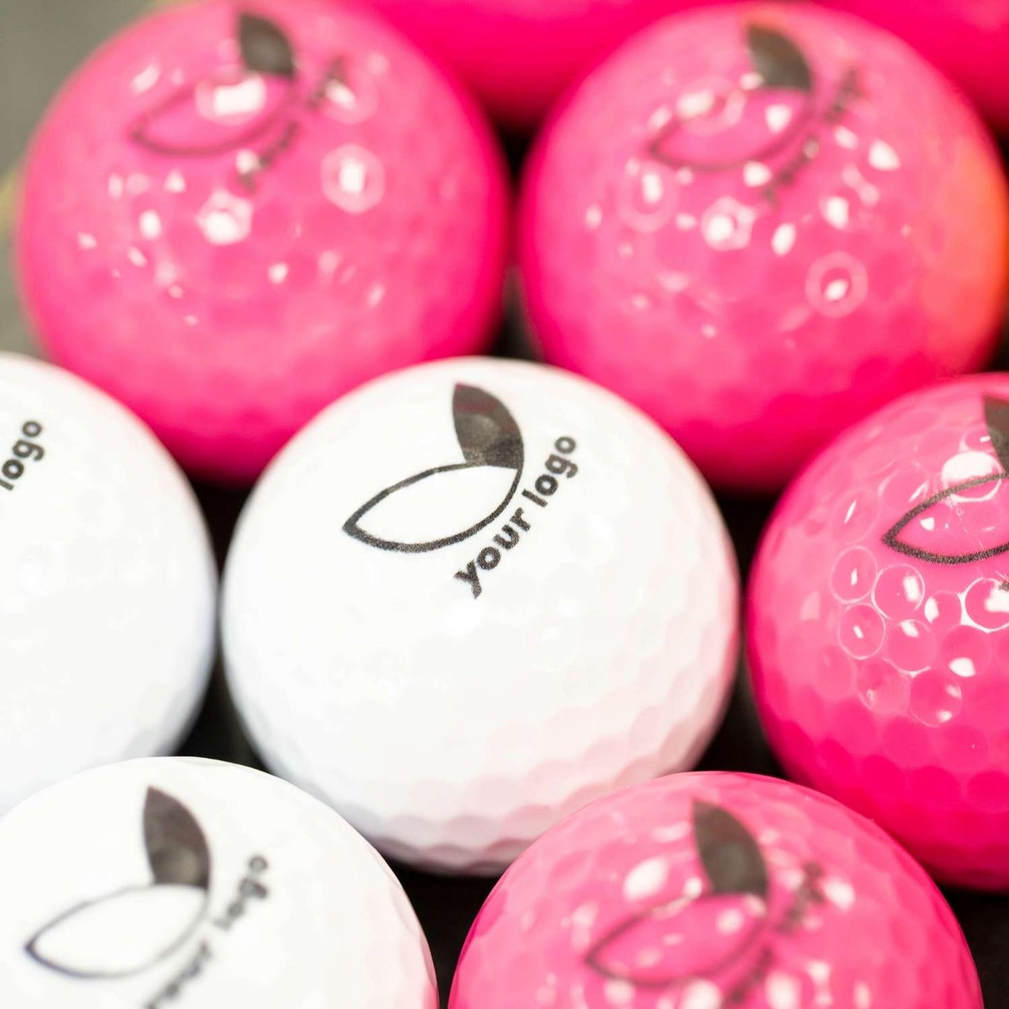 pink and white branded balls with 'your logo'