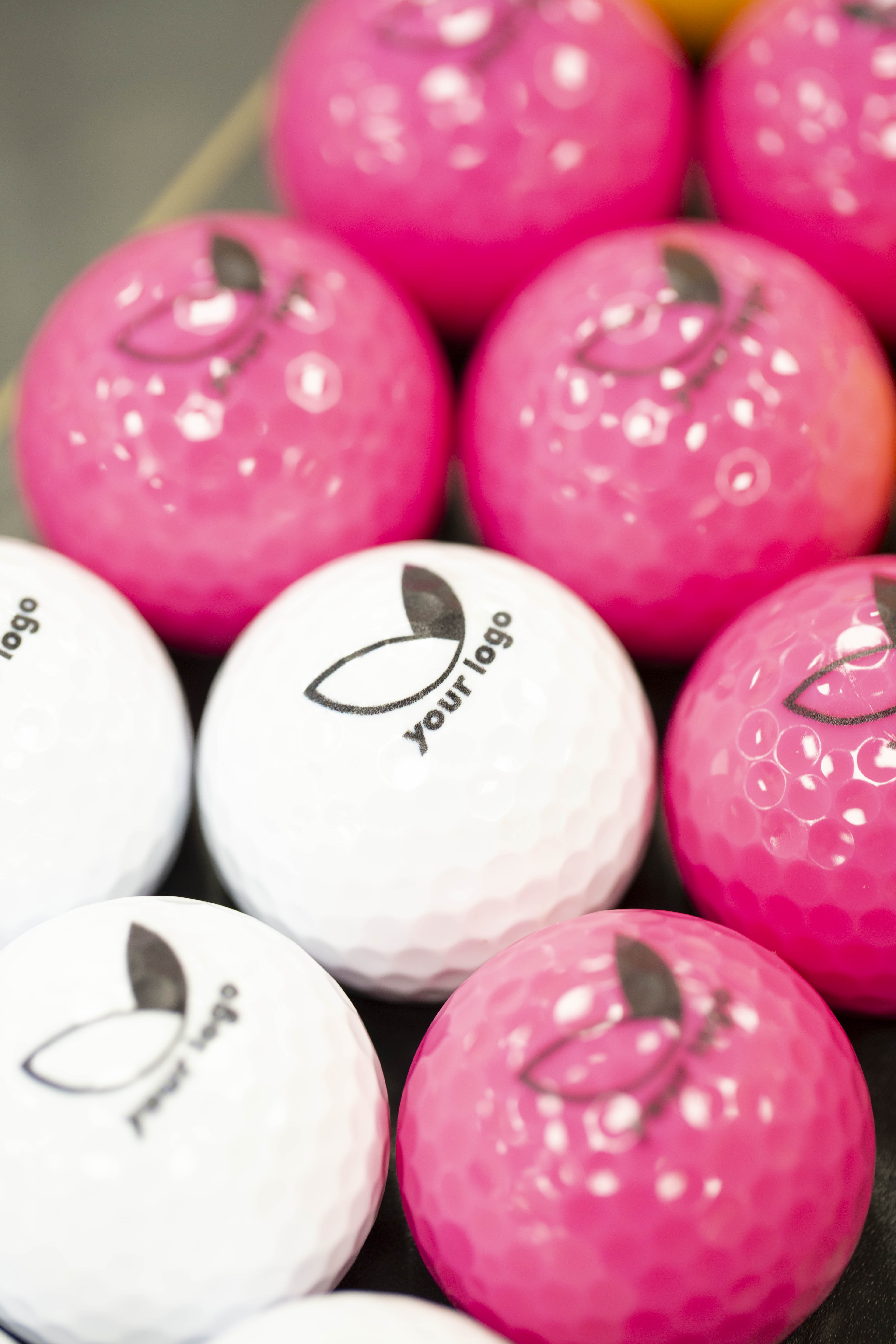 pink and white branded balls with 'your logo' 