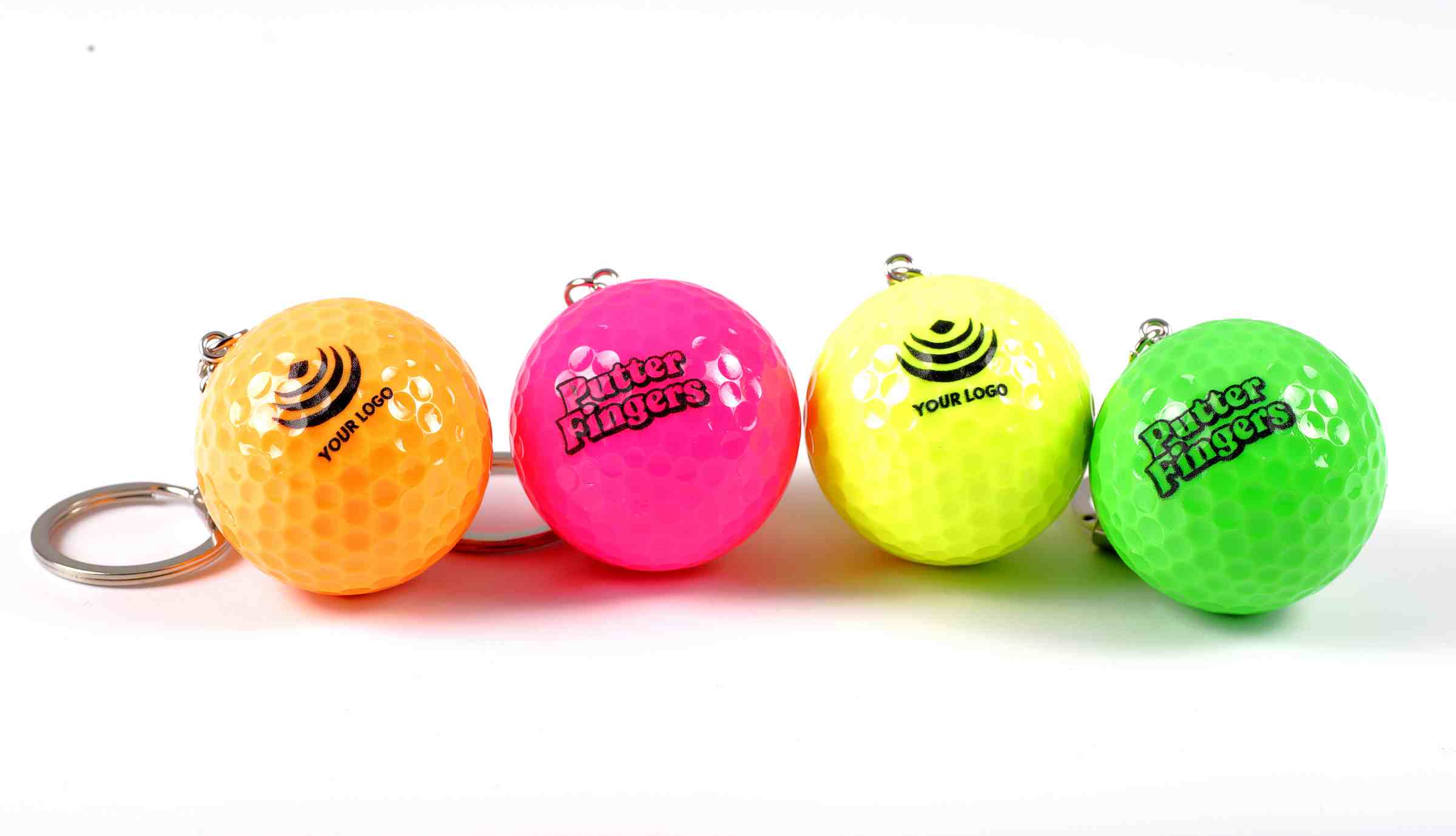 Four mini golf keyrings in vibrant orange, pink, green, and yellow. Two keyrings feature 'Your Logo' text (orange & yellow) with a generic logo, while the other two showcase the Putterfingers branding (pink & green)