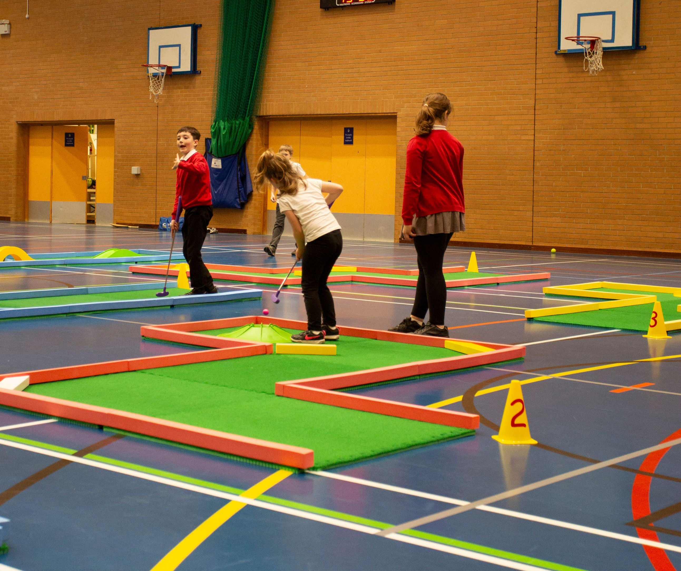 School children playing on supersize mini golf course