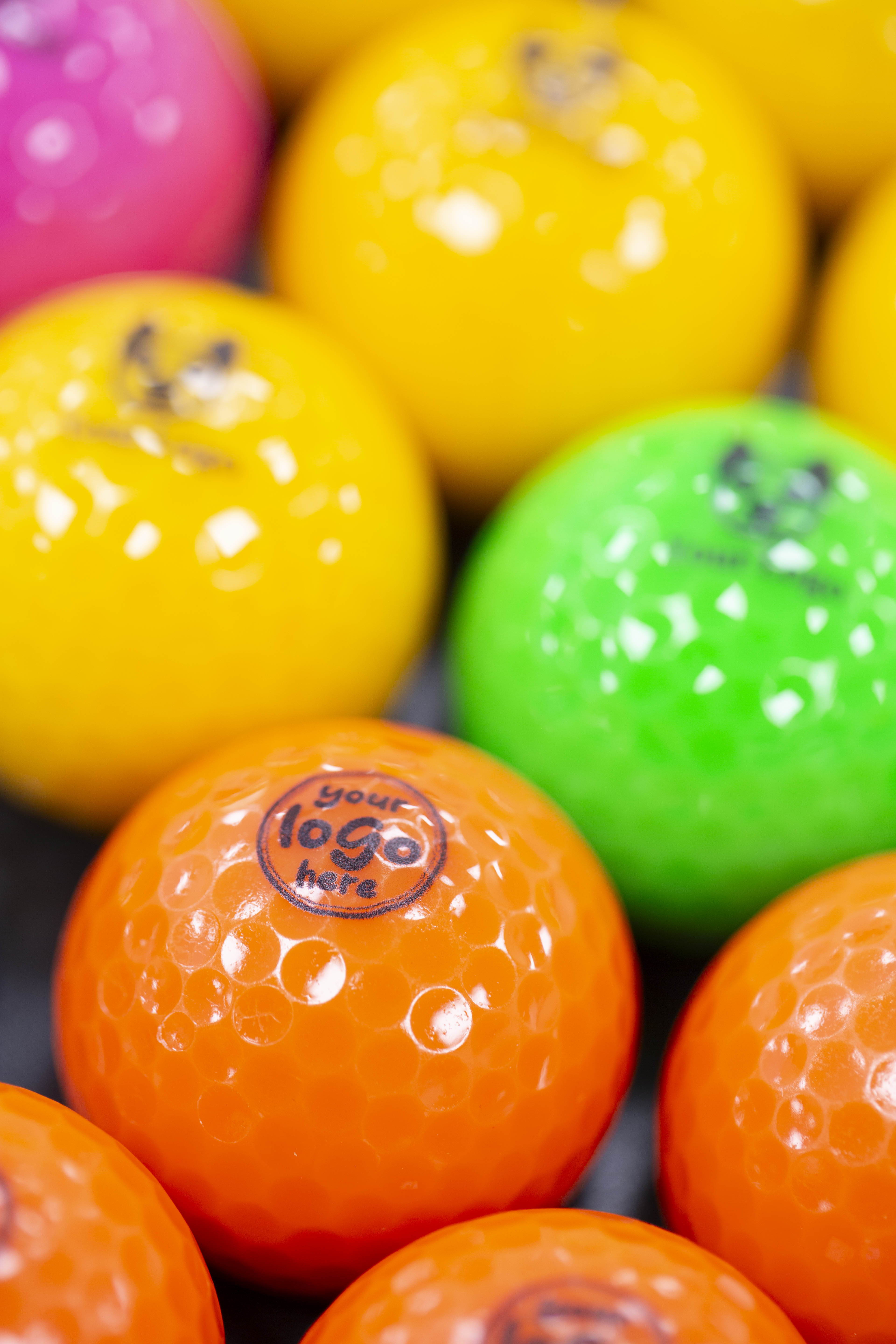 orange branded mini golf balls with 'your logo here' branding